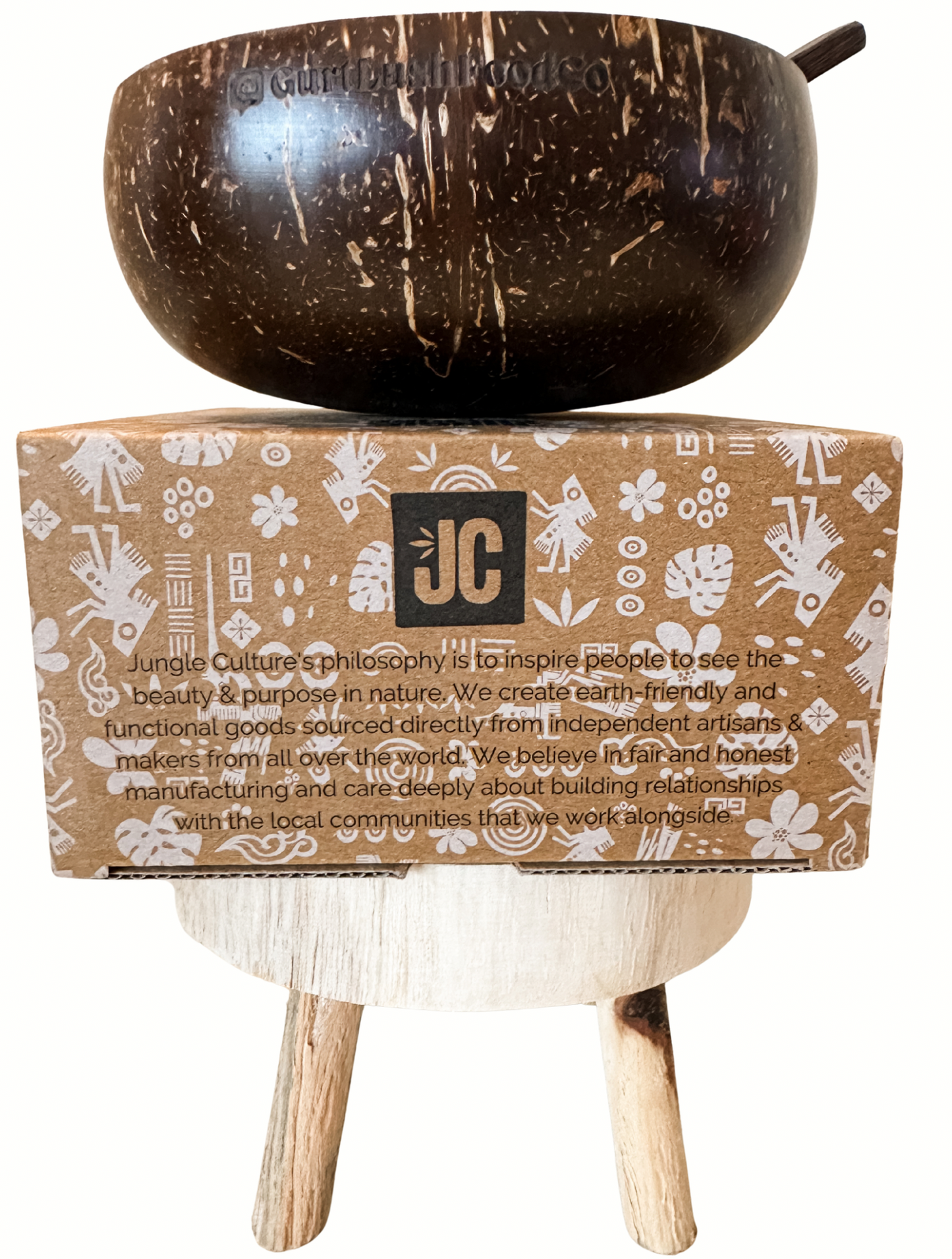 Coconut bowl on a stand with a branded box below on a white background
