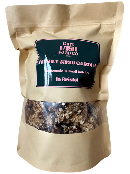 Beige bag of freshly baked granola with a label on a white background