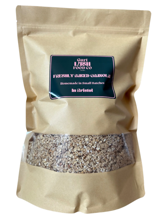 Beige bag of freshly made granola with a visible brand label on a white background