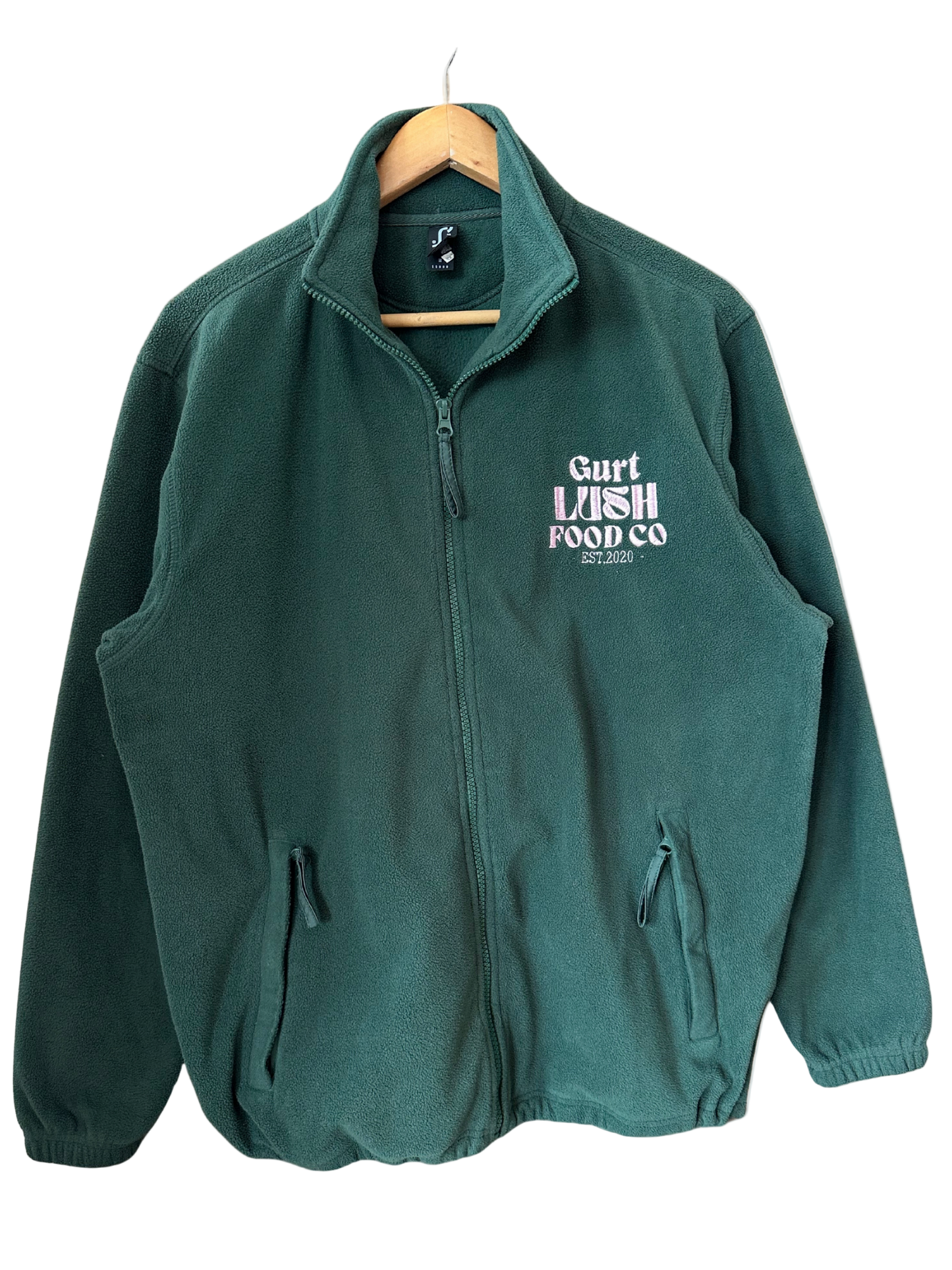 Green fleece jacket with 'Gart Lush Food Co' logo on a hanger against a white background