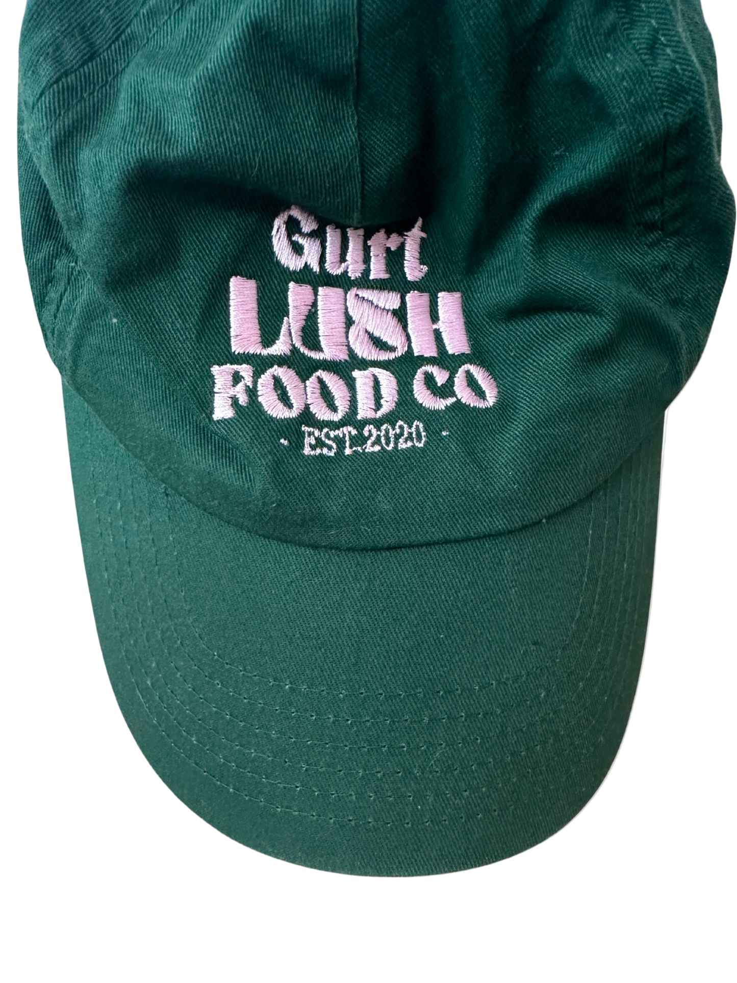 Green cap with 'Gurt Lush Food Co. EST. 2020' text on a white background