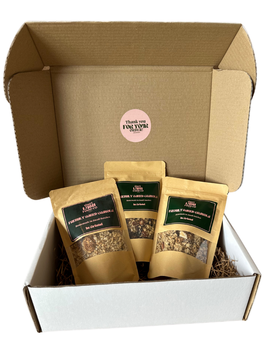 Box of granola packages with visible branding on a white background