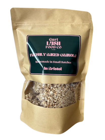 Kraft paper bag with a visible label containing granola, branded 'Gurt Lash Food Co'.