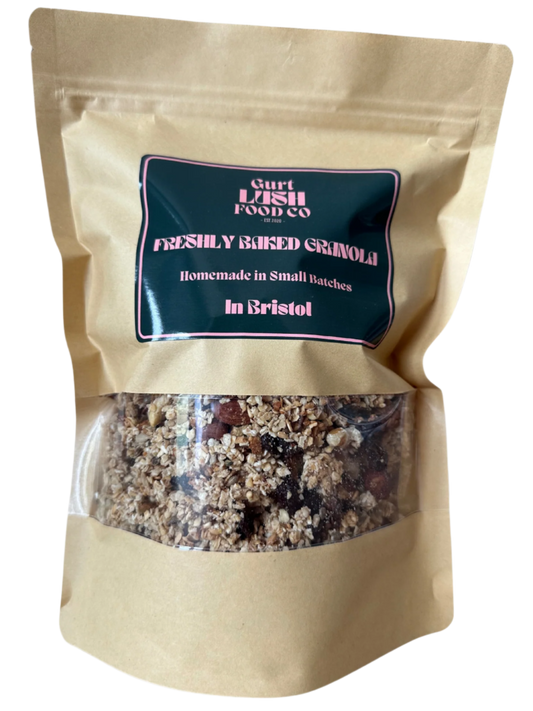 Beige packaging of freshly baked granola with a visible brand label on a white background