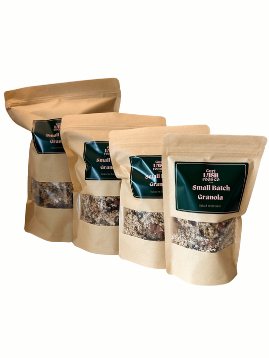 Four bags of small batch granola with visible branding on a white background