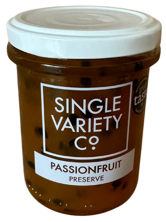 Jar of passionfruit preserve with a white lid on a white background