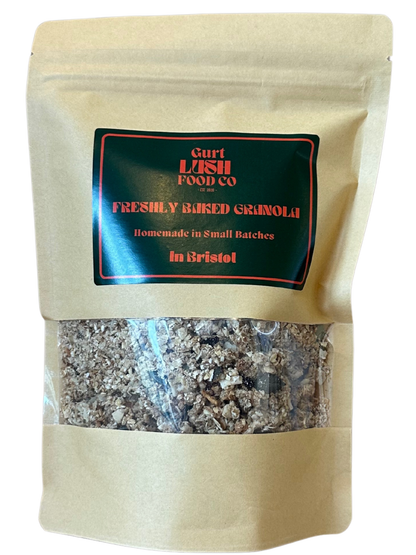 Beige bag of freshly baked granola with a visible brand label on a white background
