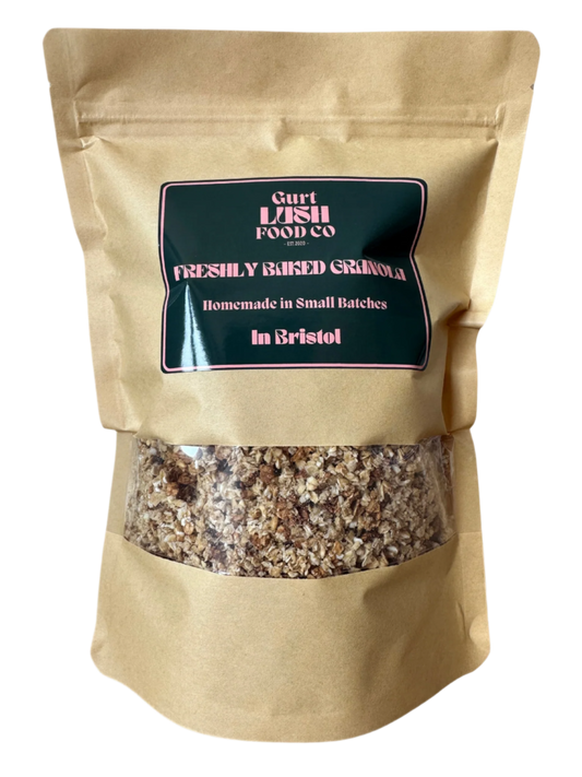 Kraft paper bag of freshly baked granola with a label on a white background