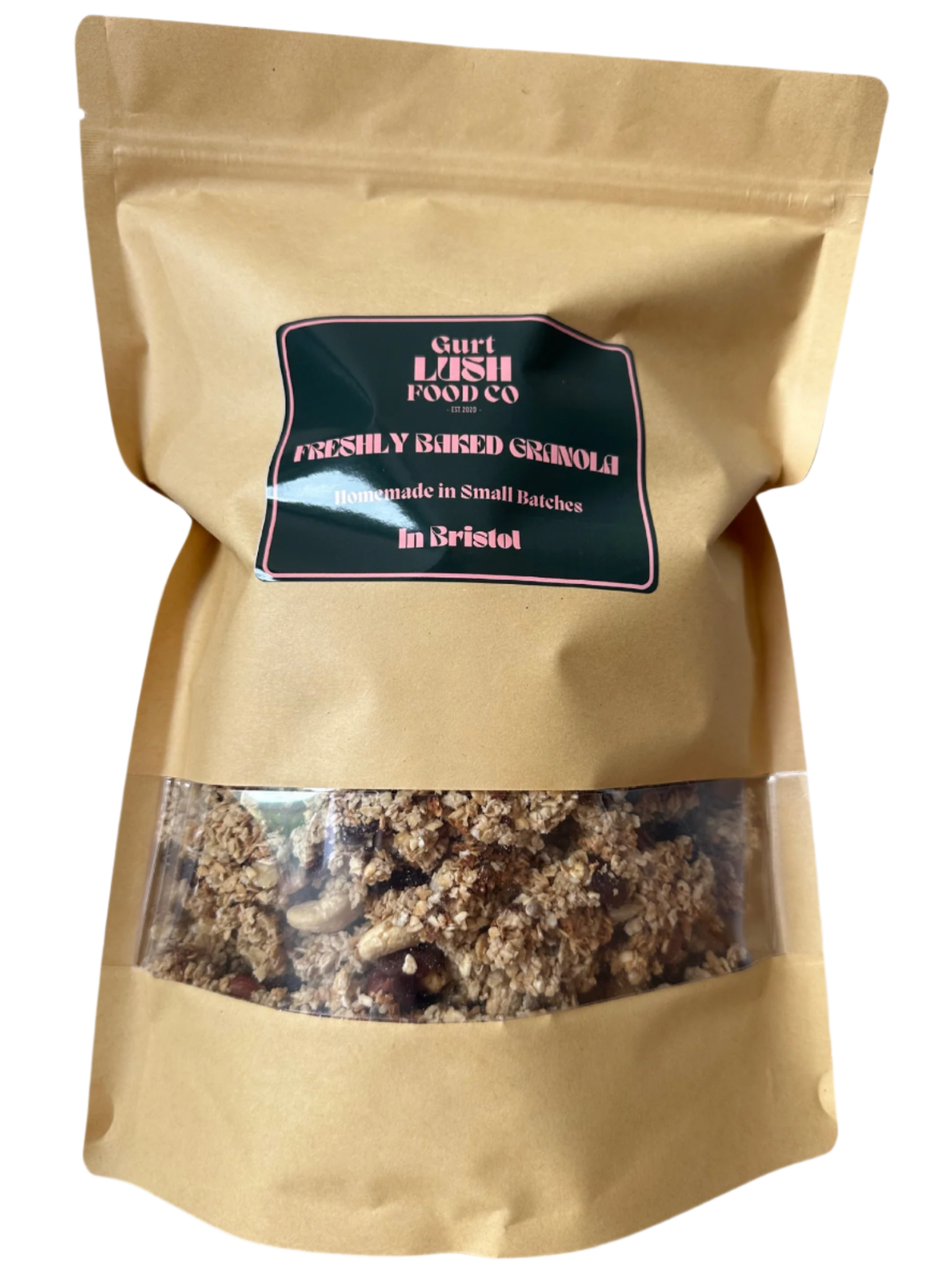 A paper bag of freshly baked granola by Gurt Lush Food Co with a clear window showing the granola inside, labeled as 'The OG' with nuts, seeds, and sultanas.