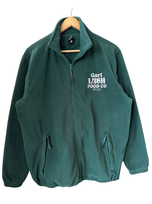 Green fleece jacket with 'Gart Lush Food Co' logo on a hanger against a white background