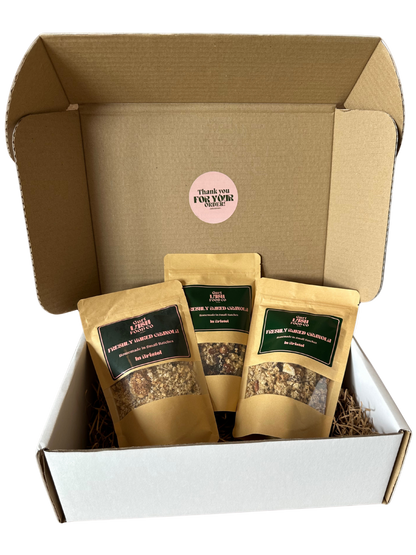Box of granola packages with visible branding on a white background