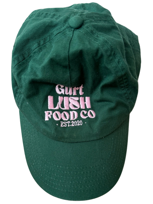 Green cap with pink text 'Gurt Lush Food Co. Est. 2020' on a white background